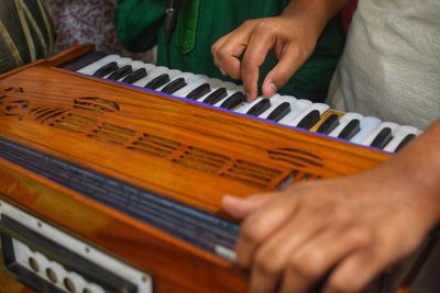 Midsection of person playing piano