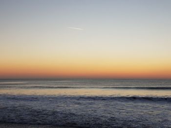 Scenic view of sea against clear sky during sunset