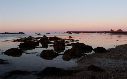 Scenic view of sea against clear sky during sunset