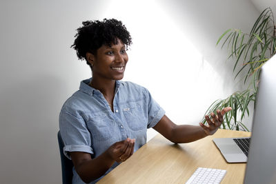 Portrait of young woman reading book at home