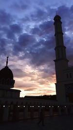 Silhouette of building against sky during sunset