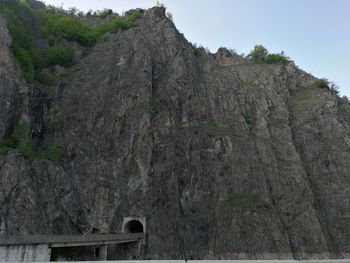 Low angle view of rocks on mountain against sky