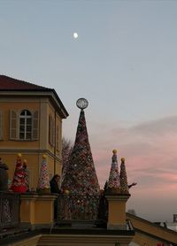 Low angle view of sculptures on building against sky