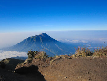 Scenic view of mountains against blue sky