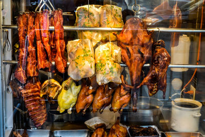 Close-up of duck meat in window for selling