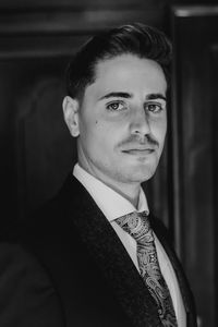 Portrait of smiling young man standing at home