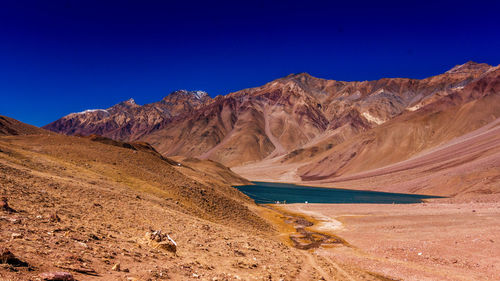 Scenic view of mountains against blue sky