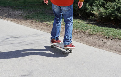 Low section of man on skateboard.