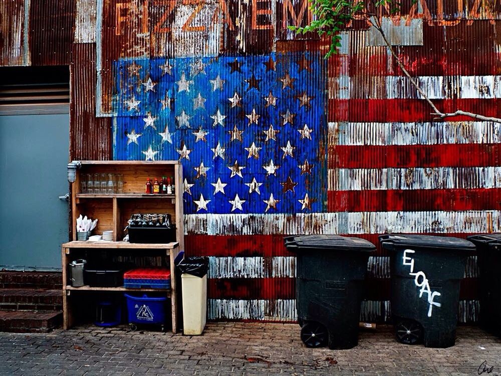 built structure, multi colored, architecture, graffiti, wall - building feature, building exterior, day, absence, blue, no people, wall, empty, variation, outdoors, in a row, large group of objects, hanging, text, clothesline, clothing