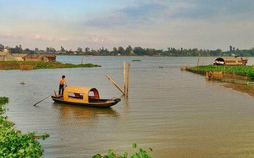 Boats in sea at sunset