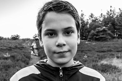 Portrait of confident boy on field