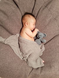 High angle view of baby sleeping on bed