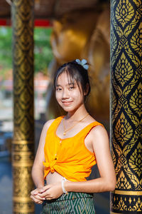 Portrait of young woman standing outdoors