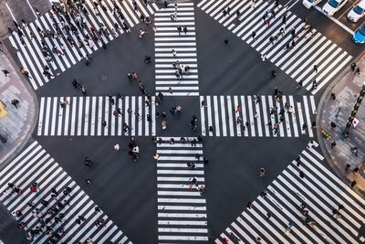 High angle view of people crossing road in city