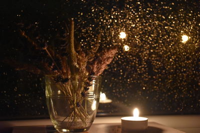 Close-up of illuminated light candle on table