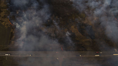 Massive fire, dry grass lanes in fire, firefighters at work, disaster, ecological catastrophe