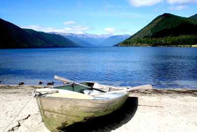 Calm lake with mountains in background