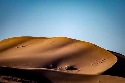 Close-up of sand dunes against clear sky