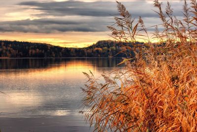 Scenic view of lake against sky at sunset