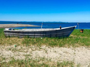 Scenic view of beach against blue sky