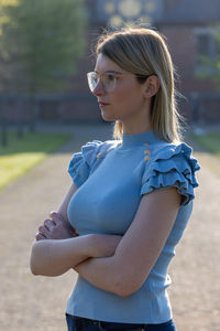 Portrait of young woman standing at beach