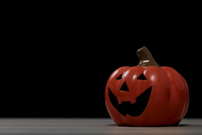 Close-up of pumpkin on table against black background