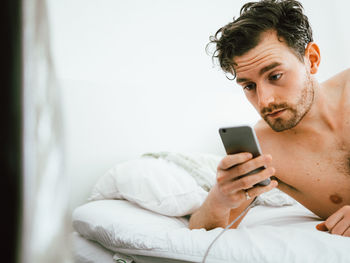 Portrait of young man using mobile phone