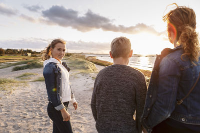 Portrait of teenager girl with family at beach