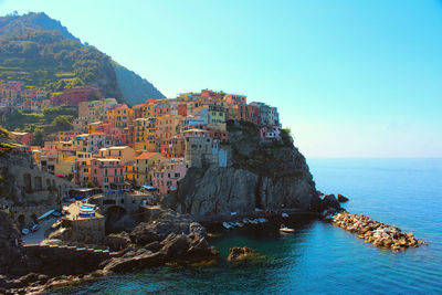 Panoramic view of sea and buildings against clear sky