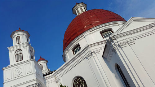 Low angle view of buildings against blue sky