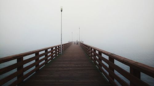 Pier over sea against sky