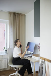 Woman at desk using cell phone