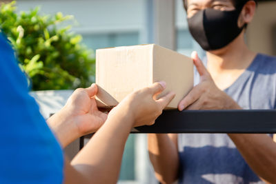 Midsection of woman holding paper