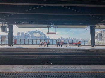 People waiting at railroad station platform