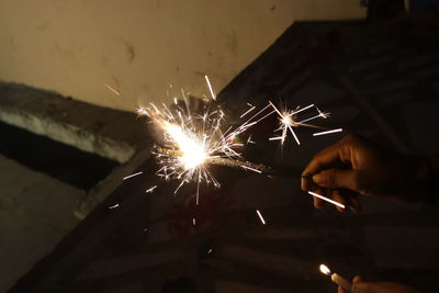 Person holding firework display at night