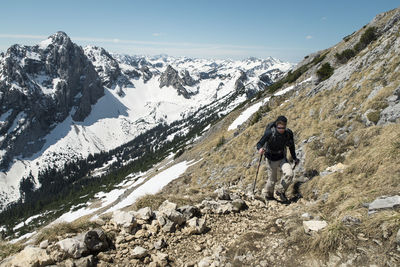 Man hiking on mountain against european alps