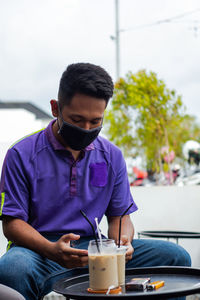 Young man sitting at restaurant
