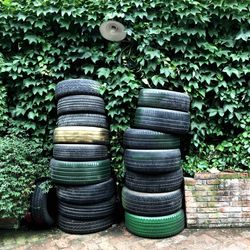 Stack of tires against plants