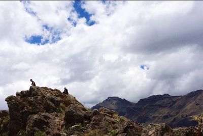 Scenic view of mountains against cloudy sky