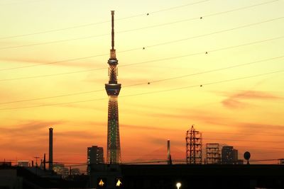 Silhouette of communications tower at sunset