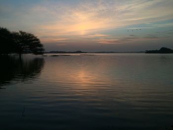 Scenic view of lake against sky during sunset