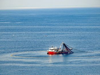 Sailboat in sea against sky