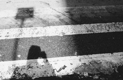 Shadow of people on road