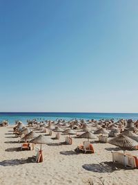 Scenic view of beach against clear blue sky