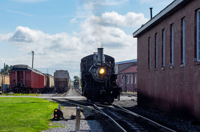 Train on railroad tracks against sky