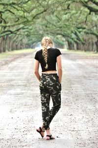 Rear view of woman walking on footpath