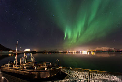 Scenic view of lake against sky at night