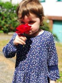 Cute boy holding flowers