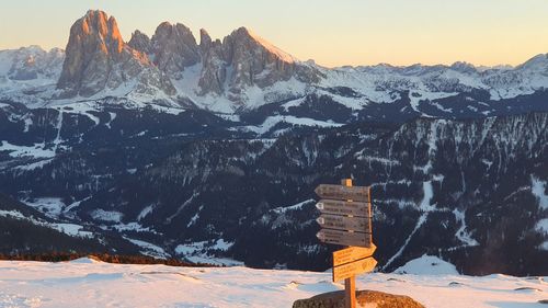 Scenic view of snowcapped mountains against sky during sunset