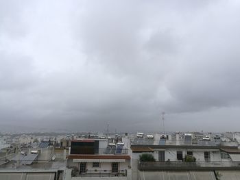 High angle view of buildings against cloudy sky